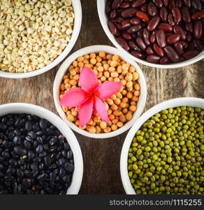 whole grains seeds various lentils with mung bean , black bean , red kidney bean , soybean and Job&rsquo;s tears - cereal mix in bowl on wooden background