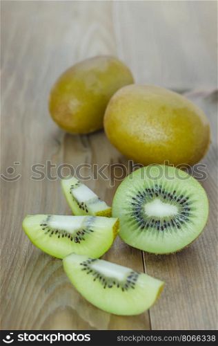 whole kiwi fruit and sliced. delicious whole kiwi fruit and sliced on wooden background