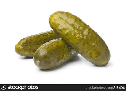 Whole pickled gherkins close up on white background