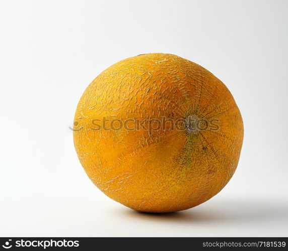 whole ripe round yellow melon on a white background, summer fruit, close up