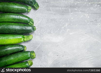 Whole ripe zucchini. On white rustic background. Whole ripe zucchini.