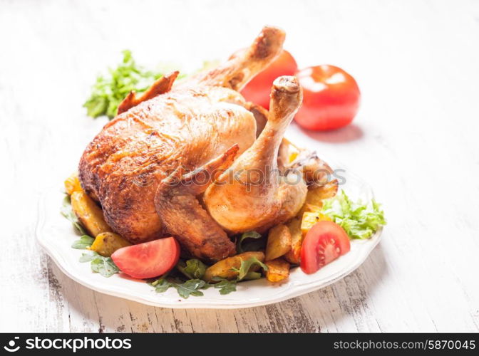 Whole Roasted Chicken on a plate with fried potatoes