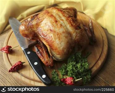 Whole roasted chicken with herb on cutting board .. Whole roasted chicken on cutting board