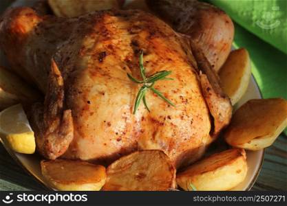 Whole roasted chicken with potatoes and lemon .. Whole roasted chicken with potatoes and lemon