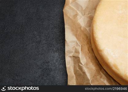 Whole round Head of parmesan or parmigiano hard cheese on concrete background or table. Whole round Head of parmesan or parmigiano hard cheese on concrete background