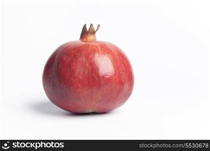 Whole single Pomegranate, Punica Granatum, on white background