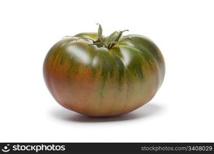 Whole single RAF heirloom tomato on white background