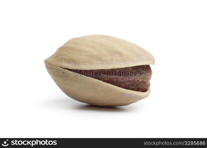 Whole single salted pistachio nut on white background