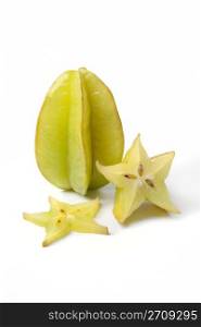 Whole starfruit with slices on white background