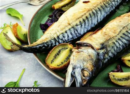 Whole tasty mackerel fish grilled with kiwi fruits.. Baked fish, grilled mackerel.