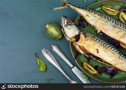 Whole tasty mackerel fish grilled with kiwi fruits. Copy space.. Baked fish, grilled mackerel.
