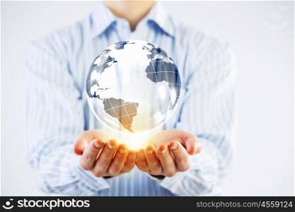 Whole world in hands. Businessman holding in palms digital Earth planet representing global technologies concept