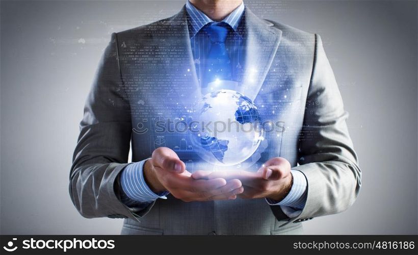 Whole world in hands. Close up of businessman holding digital globe in palm