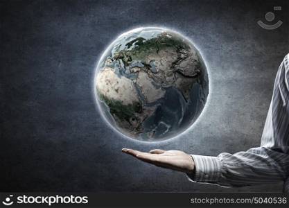 Whole world in hands. Close up of human hands holding Earth planet. Elements of this image are furnished by NASA