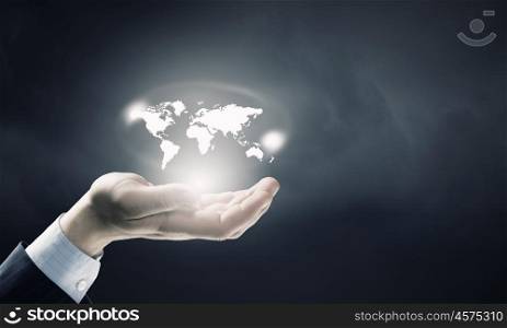 Whole world in hands. Close up of male hand holding map icon