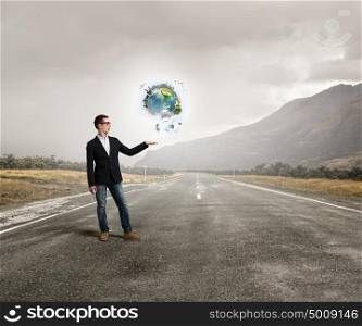 Whole world in his hand. Young businessman holding Earth planet in hand. Elements of this image are furnished by NASA