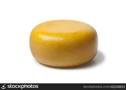 Whole yellow Dutch Gouda cheese on white background
