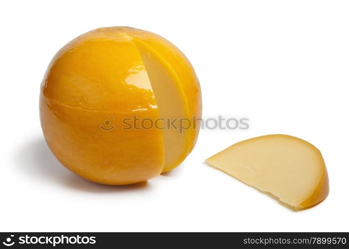 Whole yellow round Edam cheese with a slice on white background