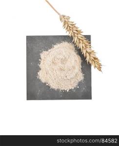 Wholegrain flour and ear on slate