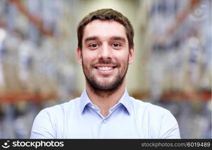 wholesale, logistic, business, export and people concept - happy man at warehouse