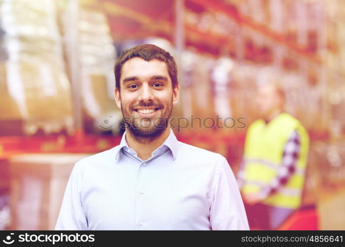 wholesale, logistic, business, export and people concept - happy man or manager at warehouse over loader on forklift