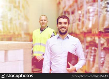 wholesale, logistic, business, export and people concept - happy man or manager with clipboard at warehouse over loader on forklift