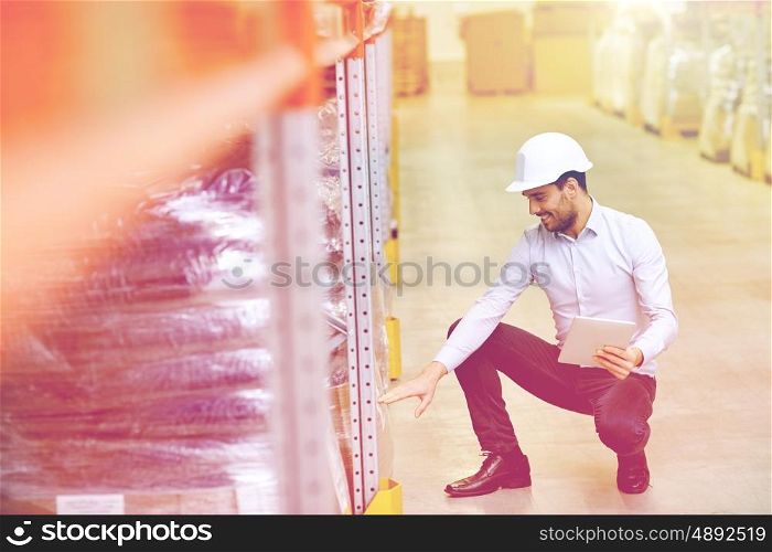 wholesale, logistic, business, export and people concept - happy man or manager with tablet pc computer checking goods at warehouse