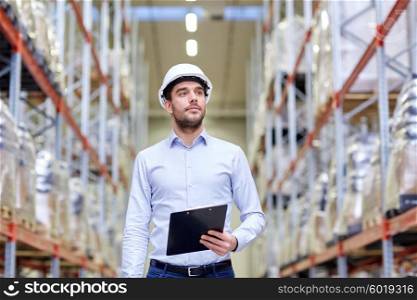 wholesale, logistic, business, export and people concept - happy man or manager with clipboard checking goods at warehouse