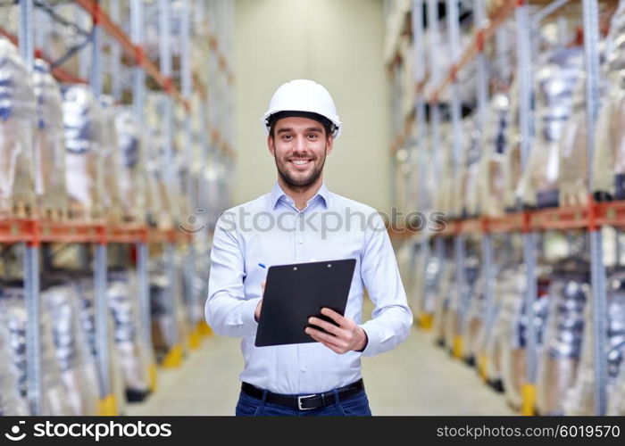 wholesale, logistic, business, export and people concept - happy man or manager with clipboard checking goods at warehouse