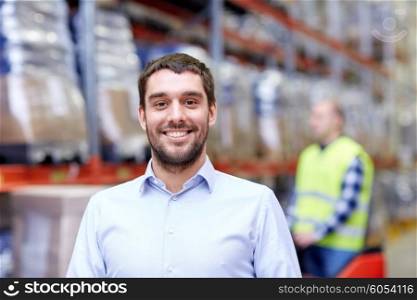 wholesale, logistic, business, export and people concept - happy man or manager at warehouse over loader on forklift