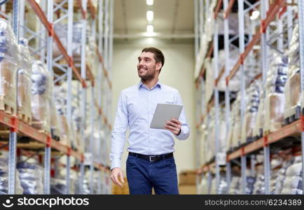 wholesale, logistic, business, export and people concept - happy man or manager with tablet pc computer checking goods at warehouse