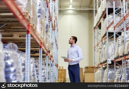 wholesale, logistic, business, export and people concept - happy man or manager with tablet pc computer checking goods at warehouse