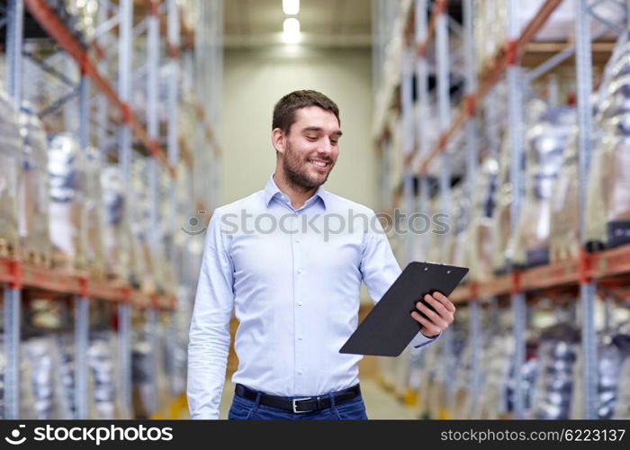 wholesale, logistic, business, export and people concept - happy man or manager with clipboard at warehouse