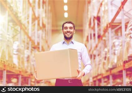 wholesale, logistic, business, export and people concept - happy man with cardboard parcel box at warehouse. happy man with cardboard parcel box at warehouse