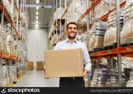 wholesale, logistic, business, export and people concept - happy man with cardboard parcel box at warehouse