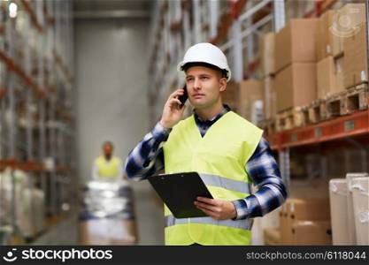 wholesale, logistic, business, export and people concept - man in hardhat and reflective safety vest with clipboard calling on smartphone at warehouse