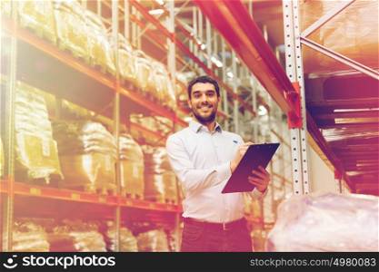 wholesale, logistic, business, export and people concept - man or manager with clipboard checking goods at warehouse. businessman with clipboard at warehouse