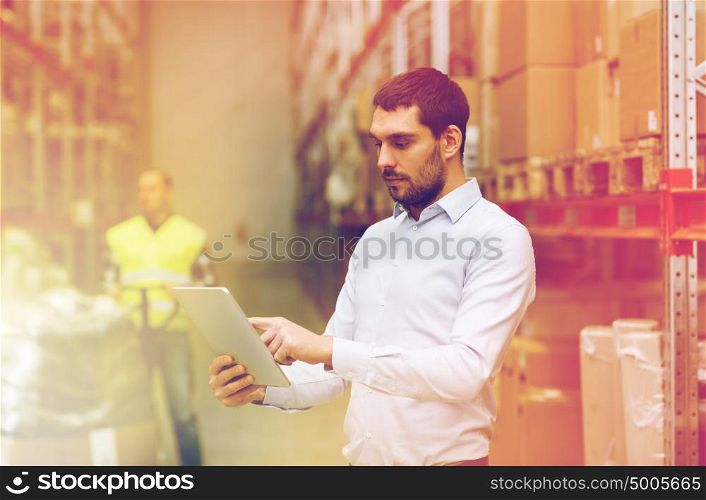 wholesale, logistic, business, export and people concept - man or manager with tablet pc computer checking goods at warehouse. businessman with tablet pc at warehouse