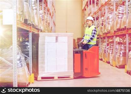 wholesale, logistic, loading, shipment and people concept - man or loader with forklift or loader loading boxes at warehouse