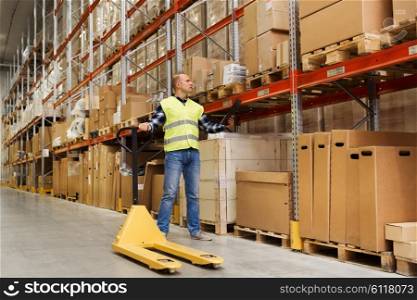 wholesale, logistic, loading, shipment and people concept - man with empty loader and clipboard at warehouse