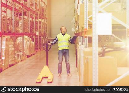 wholesale, logistic, loading, shipment and people concept - man with loader and clipboard at warehouse. man with loader and clipboard at warehouse