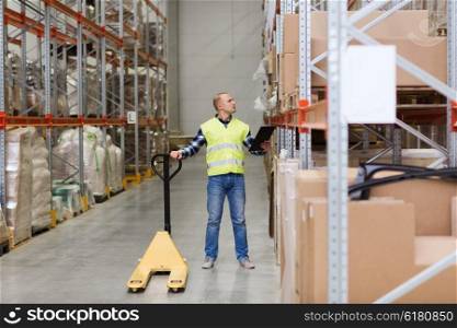 wholesale, logistic, loading, shipment and people concept - man with loader and clipboard at warehouse