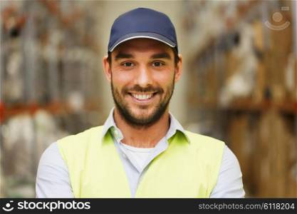 wholesale, logistic, people and export concept - happy man in cap and reflective safety vest at warehouse