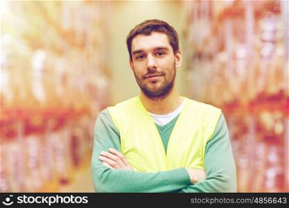 wholesale, logistic, people and export concept - happy man in reflective safety vest at warehouse
