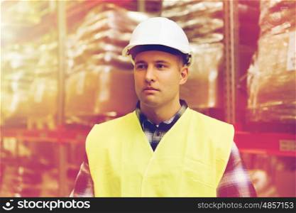 wholesale, logistic, people and export concept - man in reflective safety vest and hardhat at warehouse