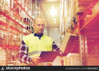 wholesale, logistic, people and export concept - man with clipboard and box in reflective safety vest at warehouse