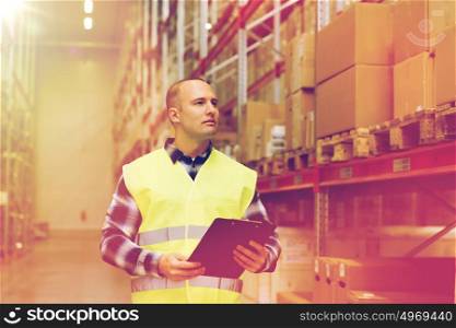 wholesale, logistic, people and export concept - man with clipboard in reflective safety vest at warehouse. man with clipboard in safety vest at warehouse