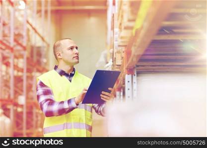 wholesale, logistic, people and export concept - man with clipboard in reflective safety vest at warehouse. man with clipboard in safety vest at warehouse
