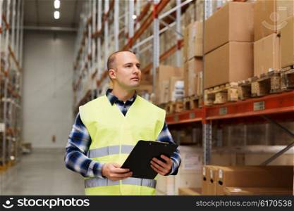 wholesale, logistic, people and export concept - man with clipboard in reflective safety vest at warehouse