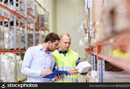 wholesale, logistic, people and export concept - manual worker and businessmen with clipboard and box at warehouse